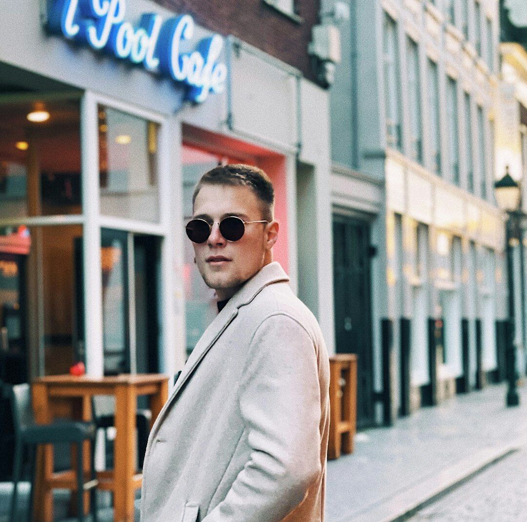 Professional Belgian man in his 40s wearing glasses and a dark suit