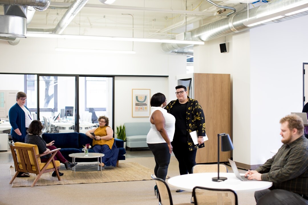 Diverse startup team collaborating around laptops in a bright modern office